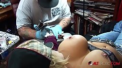 Shyla Stylez gets tattooed while playing on every side her tits